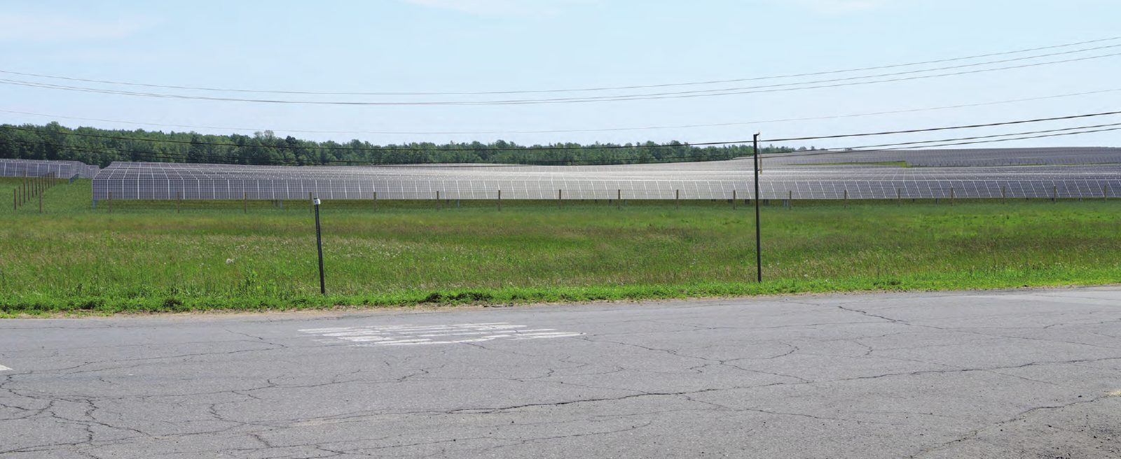 The same view with rows of solar panels simulated across the field